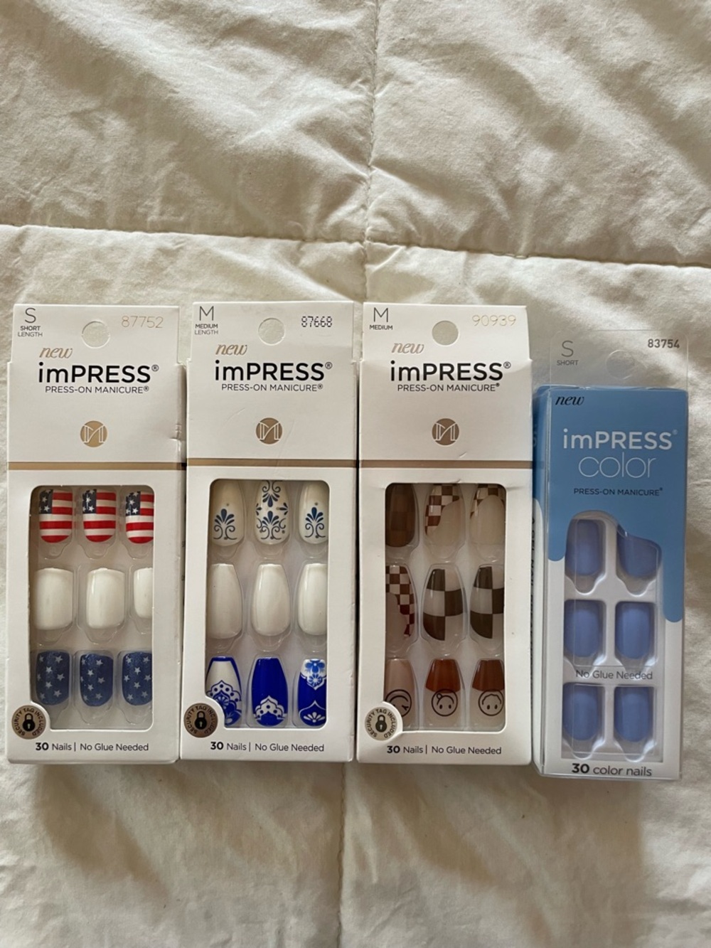 imPRESS Press-On Nails - Blue, White, Red, Brown Accents. Four sets of nails.